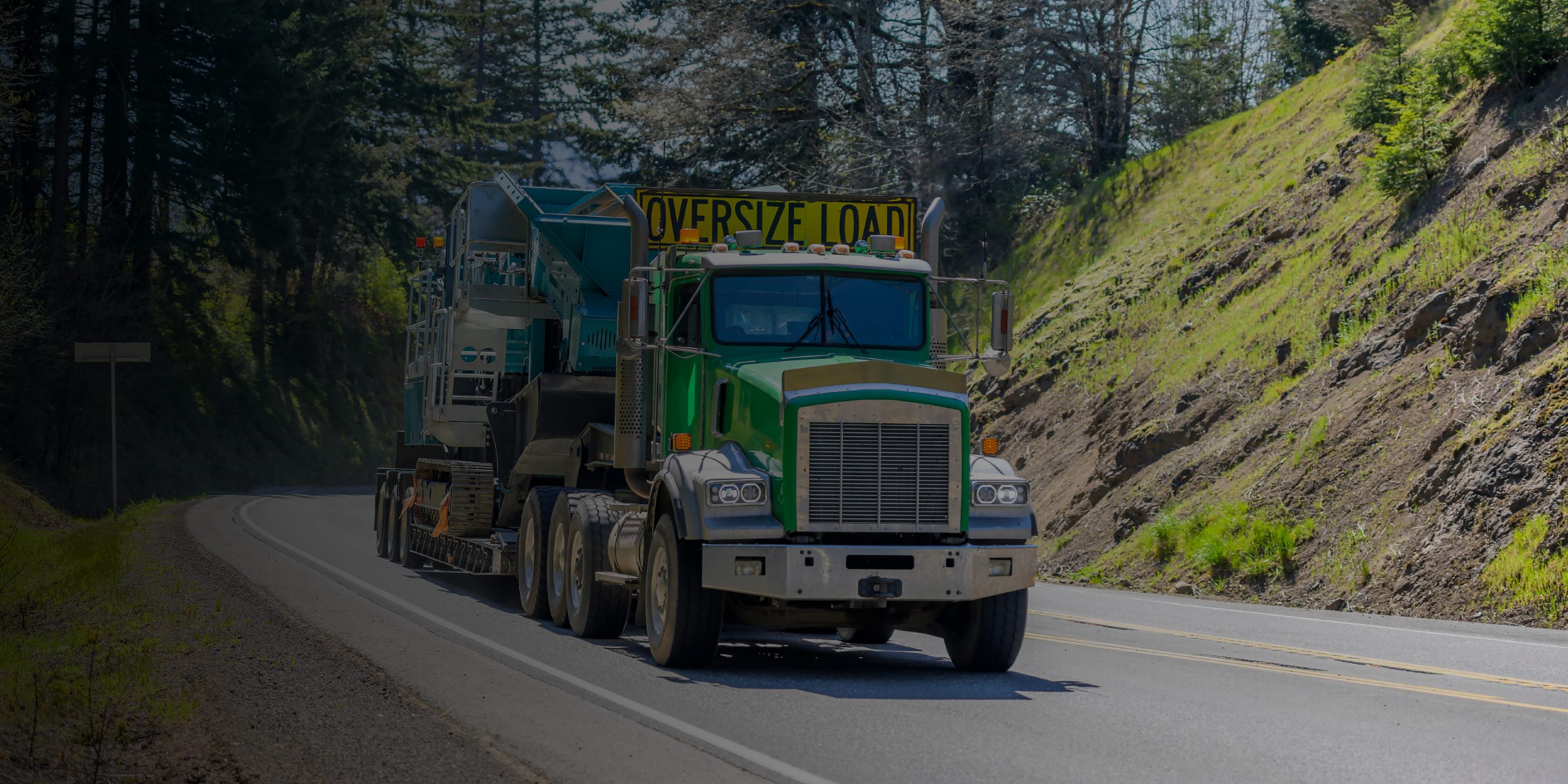 oversized truck carrying construction equipment