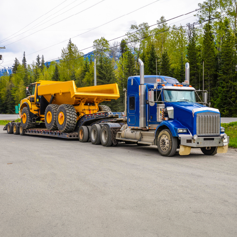 drop deck oversized truck hauling construction equipment